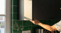 Black, Bold Cabinets and Dramatic Green Tiles Refresh This 2000s Kitchen